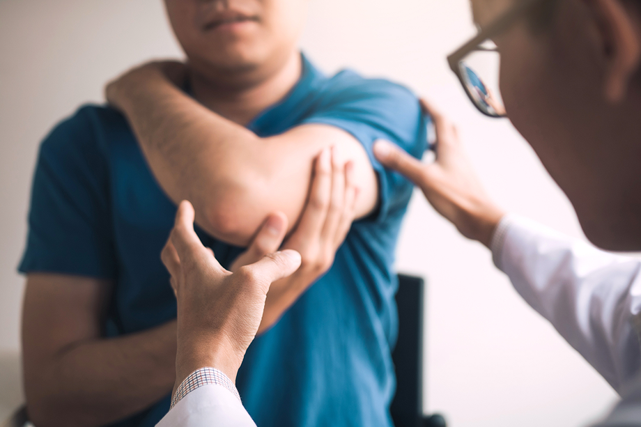 Image of a doctor examining under a patients arm.